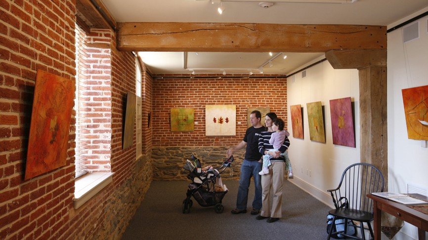 family looking at art in gallery