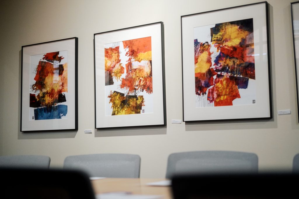 three art pieces on a gallery wall