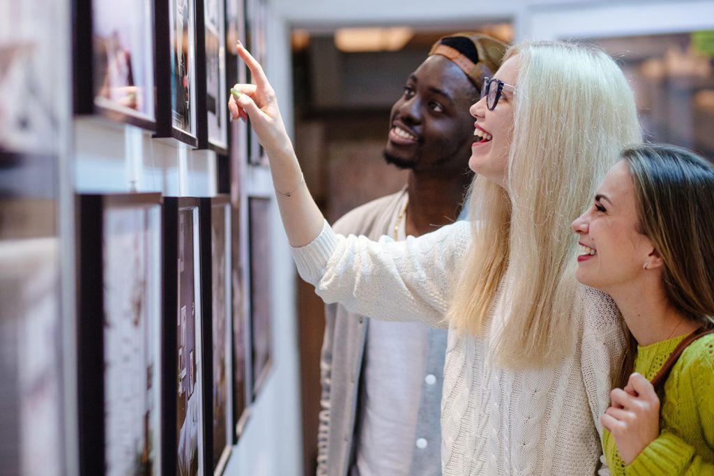 three people enjoying an art gallery